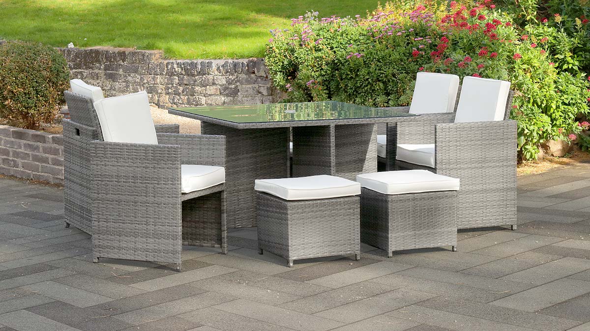 The Premium 8 Seat Cube Rattan Dining Set in Grey on an outside patio