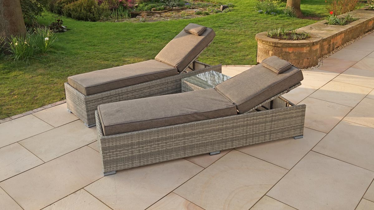 The Liv Outdoors Windsor Sun Loungers and table on an outside patio